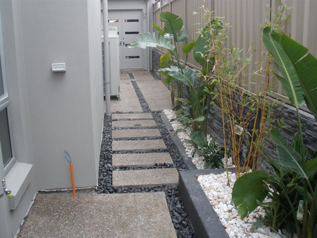 Stepping stones and small concrete garden beds in contrasting colours
